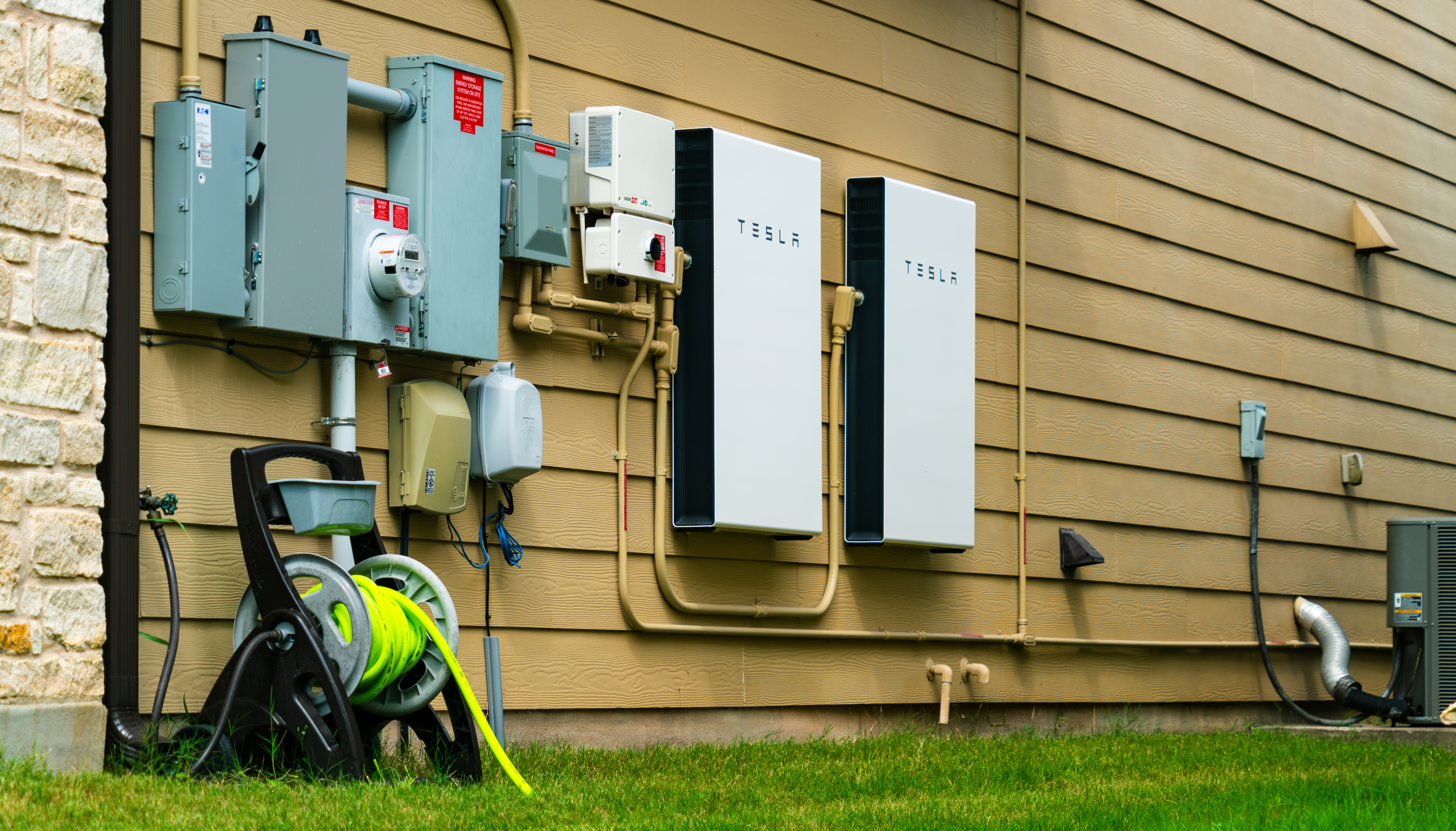 Tesla Powerwall Battery storage on side of building