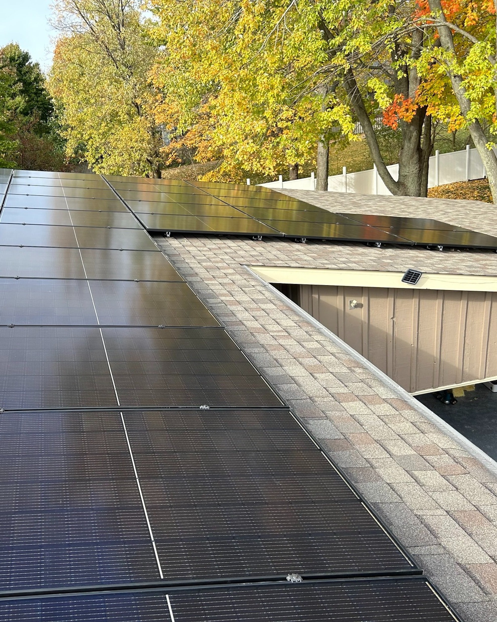 house with rooftop solar installation during the fall