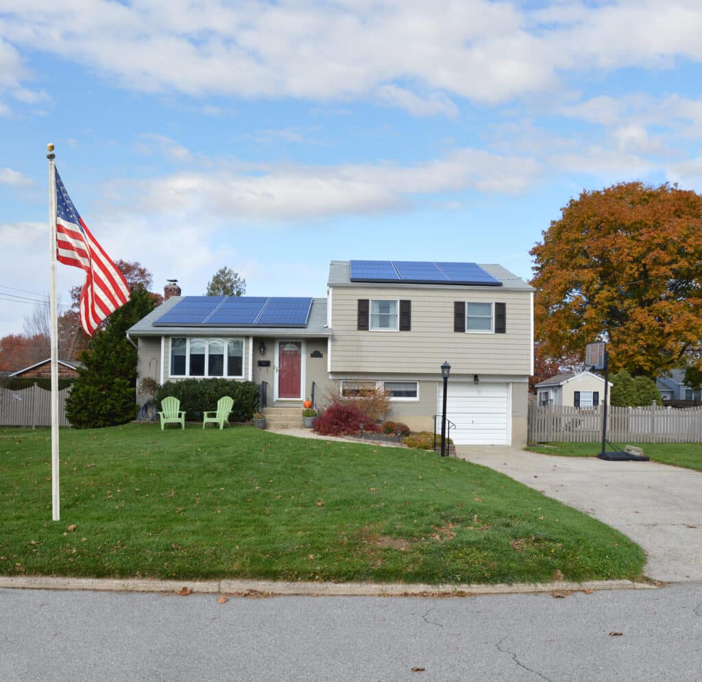 american flag pole suburban high ranch house autumn day residential neighborhood in the us
